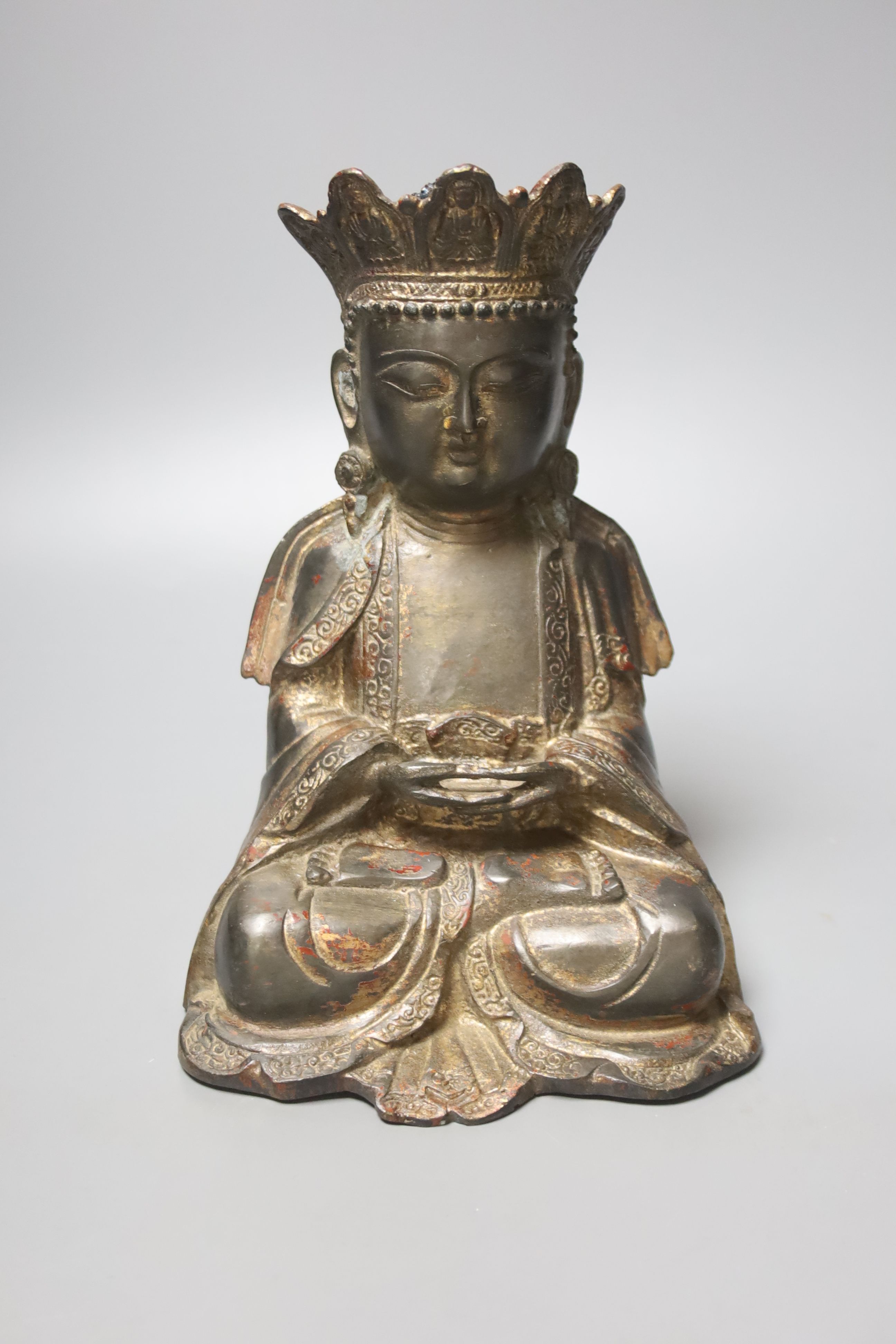 A Chinese gilt lacquered bronze figure of a seated and crowned Buddha, Ming dynasty or later, 21cm high